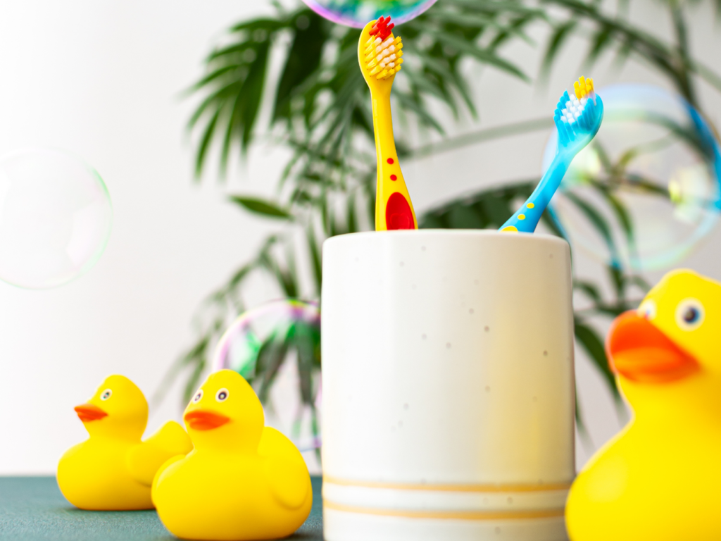 Colorful toothbrushes stand in a cup